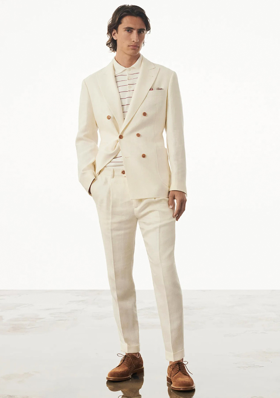 Beige double-breasted suit, white striped polo t-shirt, and brown brogues