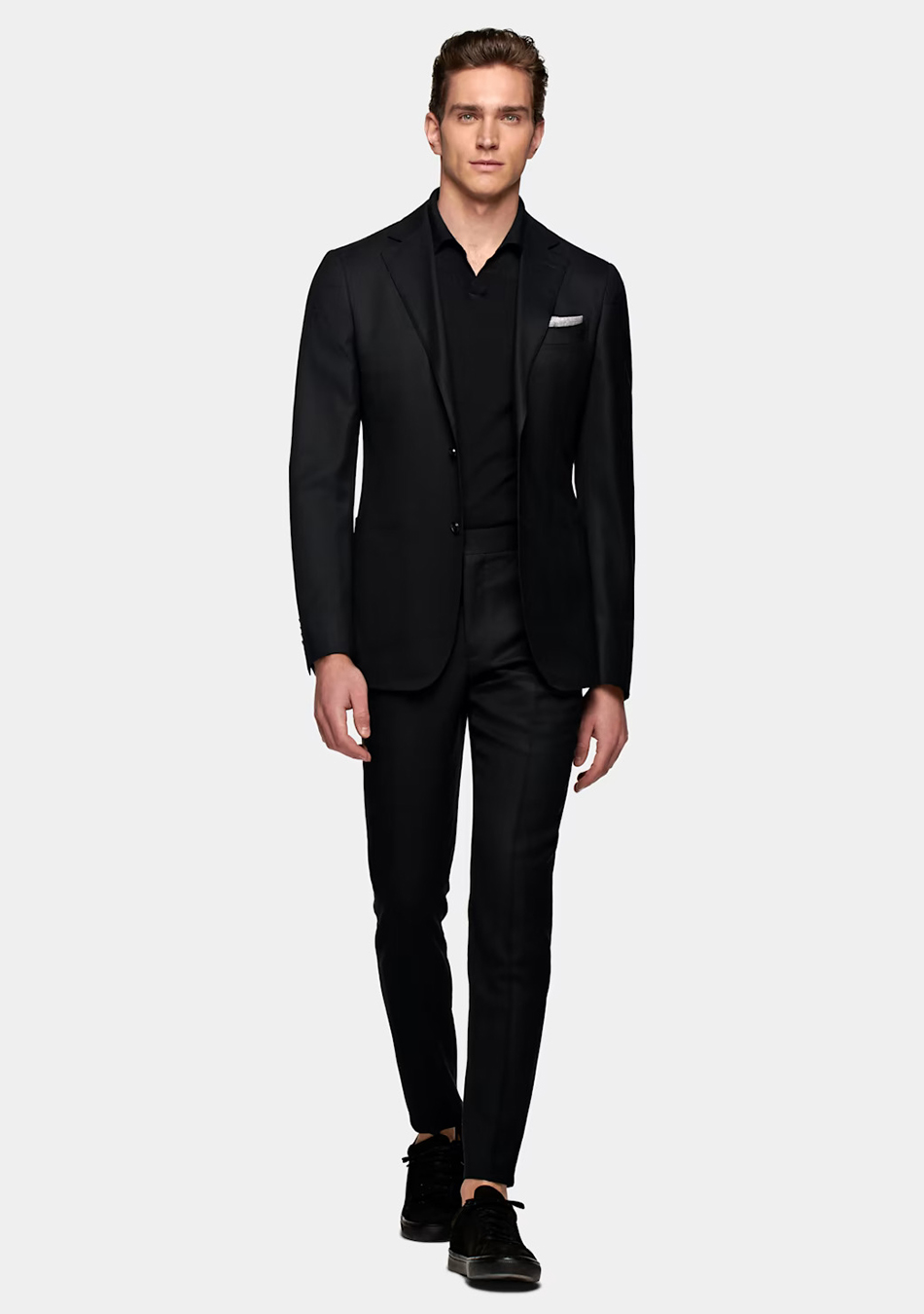 Black suit, black polo shirt, and black sneakers
