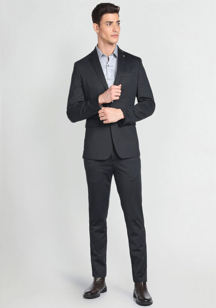 Black suit, blue dress shirt, and black Chelsea boots