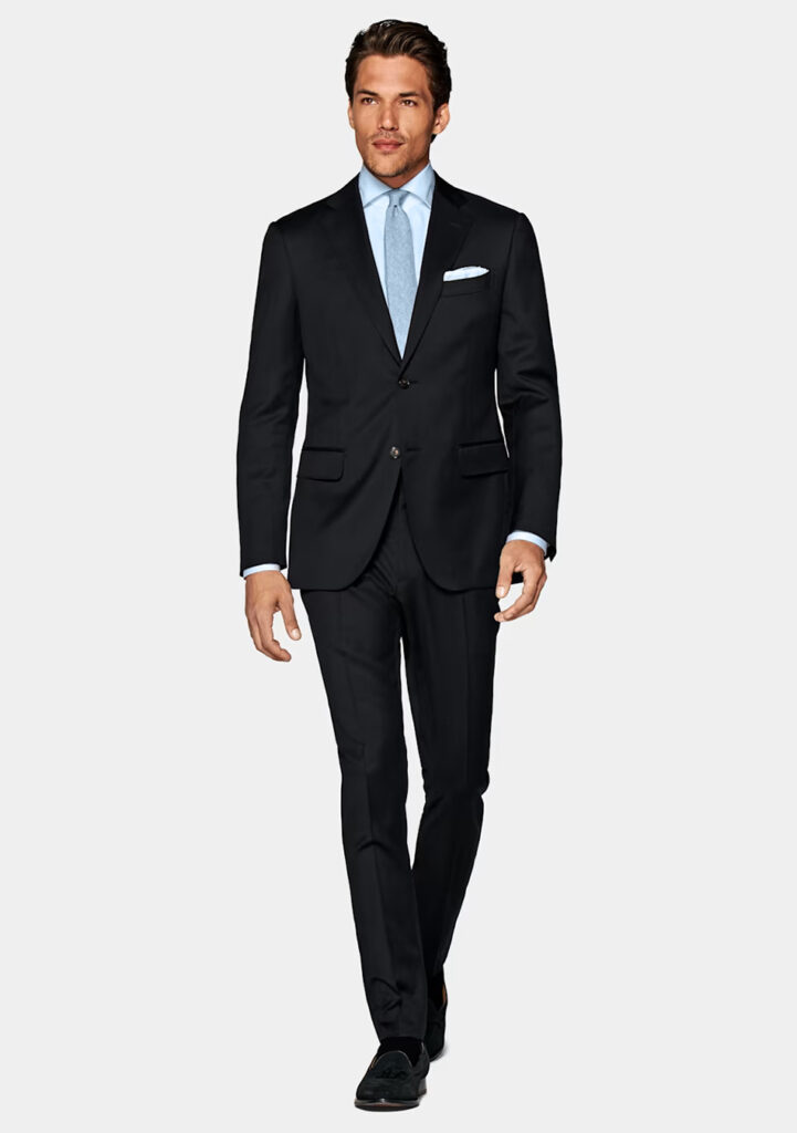 Black suit, blue shirt, blue tie, and black loafers