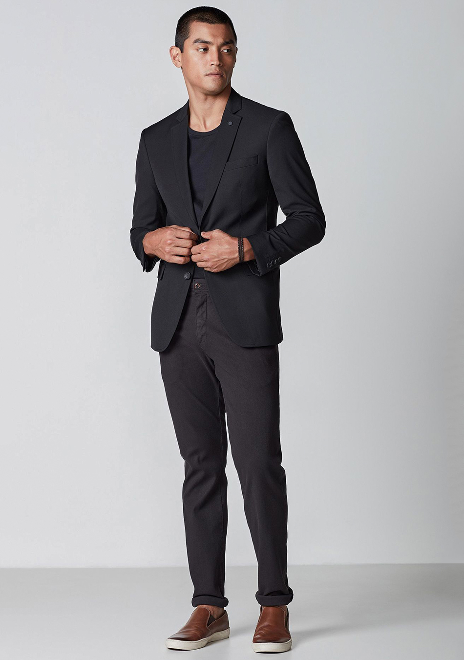 Black suit jacket, black t-shirt, black chinos, and brown sneakers