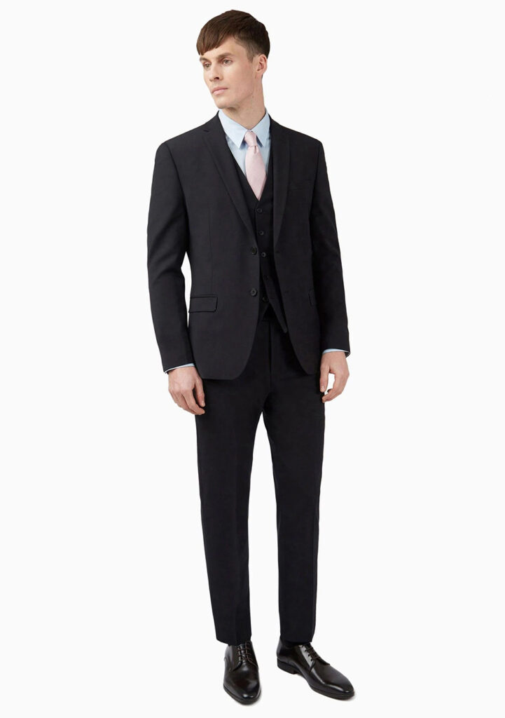 Black three-piece suit, blue shirt, and pink tie