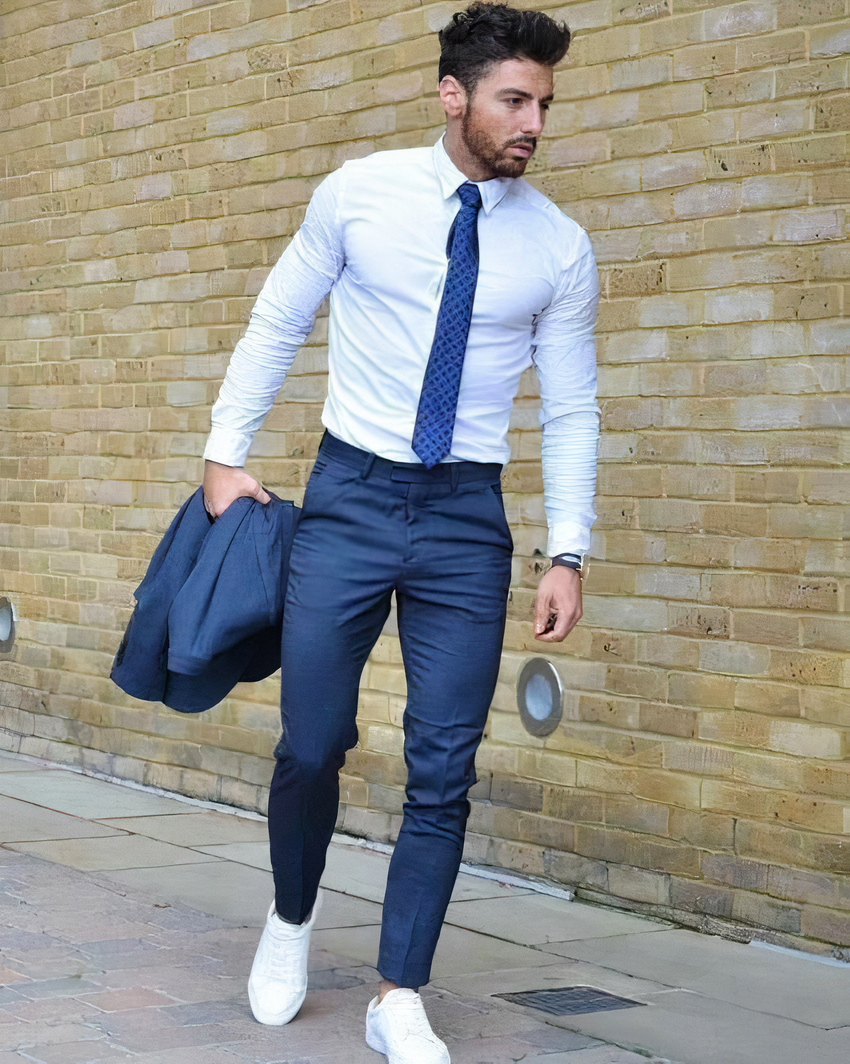 Blue suit jacket and pants, blue tie, white shirt, and white sneakers