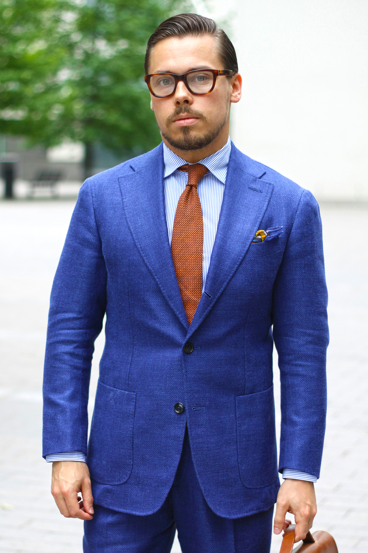 Blue suit, light blue shirt, and dark orange tie