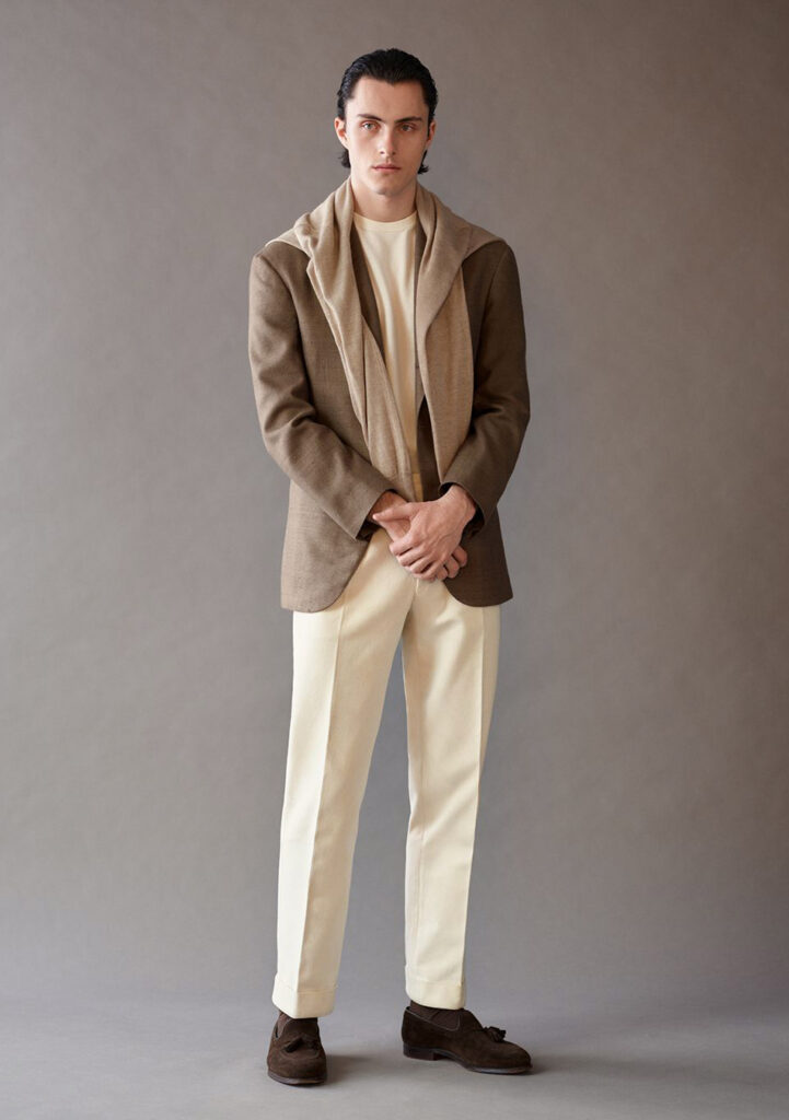 Brown blazer and beige pants paired with a beige sweater and brown loafers