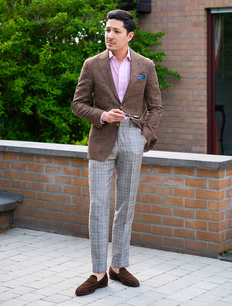Brown blazer, pink shirt, grey pants, and brown loafers