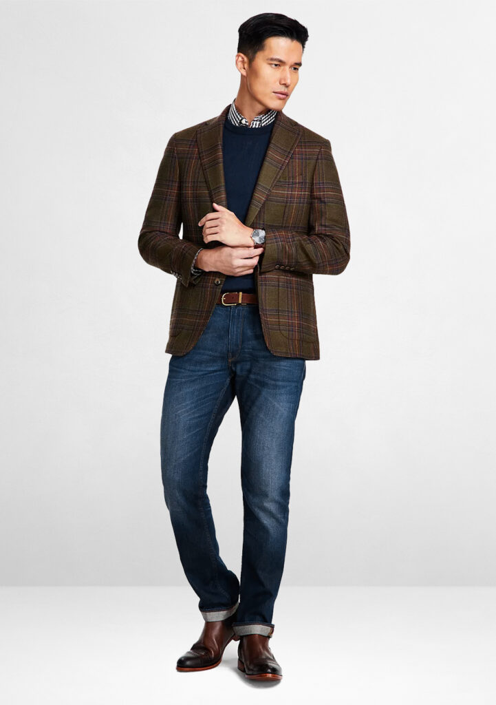 Brown tweed blazer, navy sweater, and blue jeans