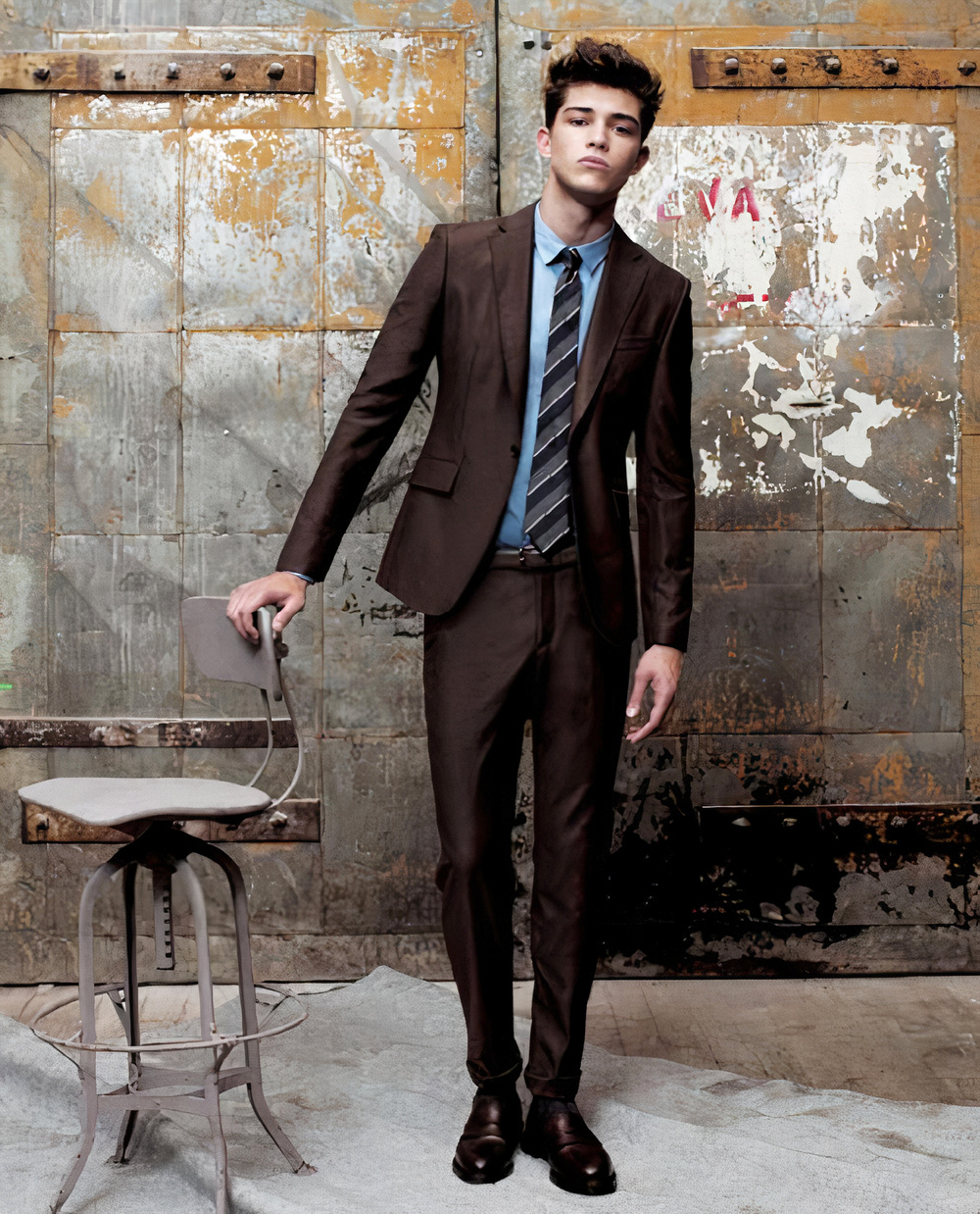 Brown suit, blue dress shirt, and black & brown striped tie