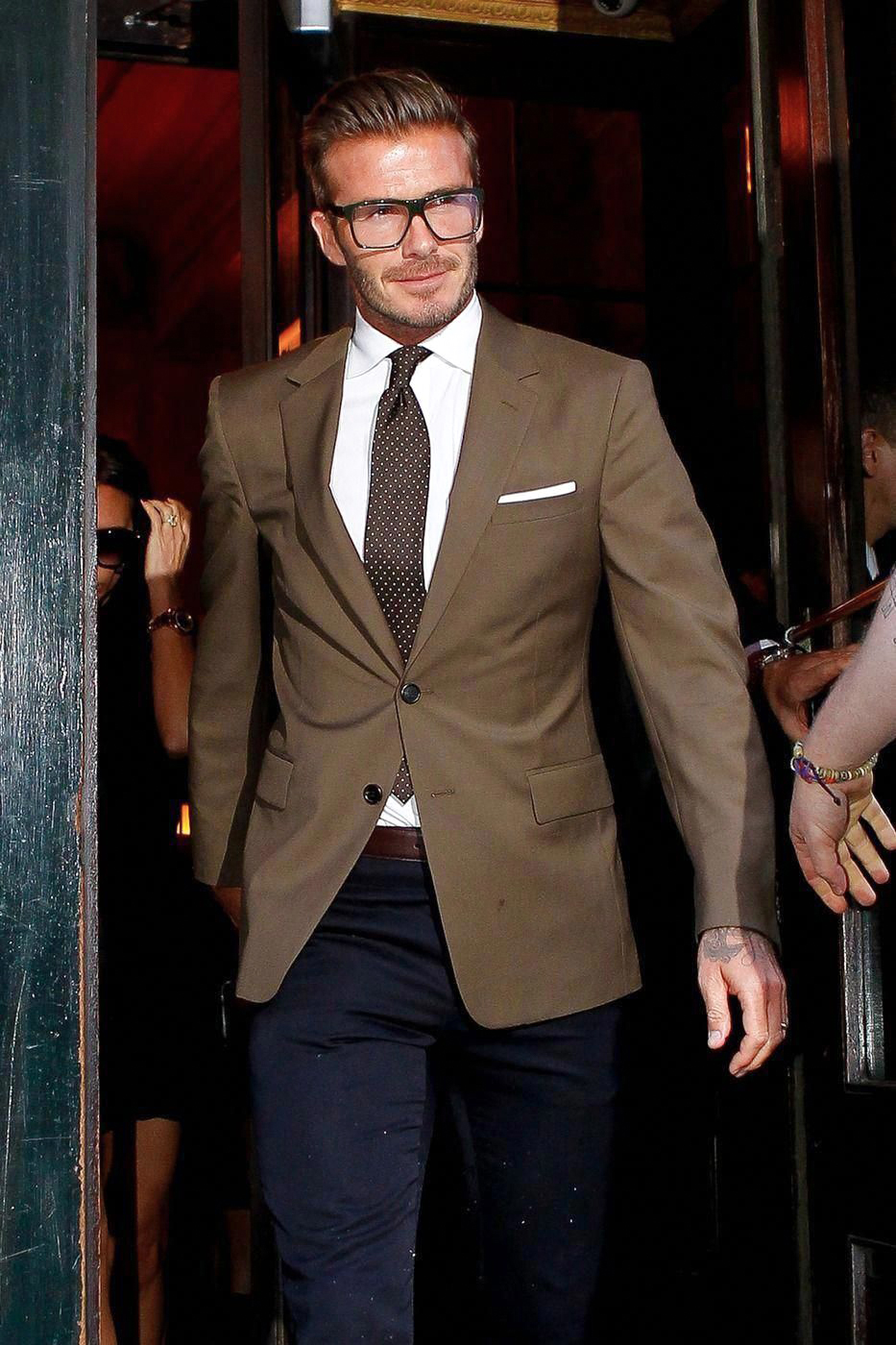 Brown suit jacket, navy pants, white shirt, and brown tie