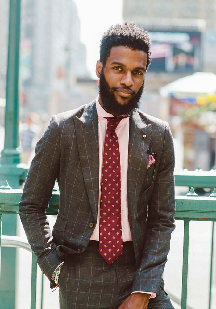 Brown suit, pink shirt, and maroon patterned tie