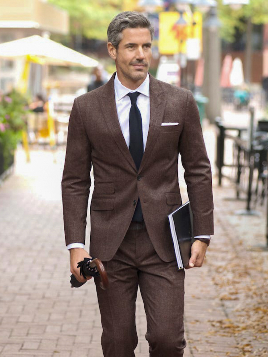 Brown suit, white shirt, and solid black tie