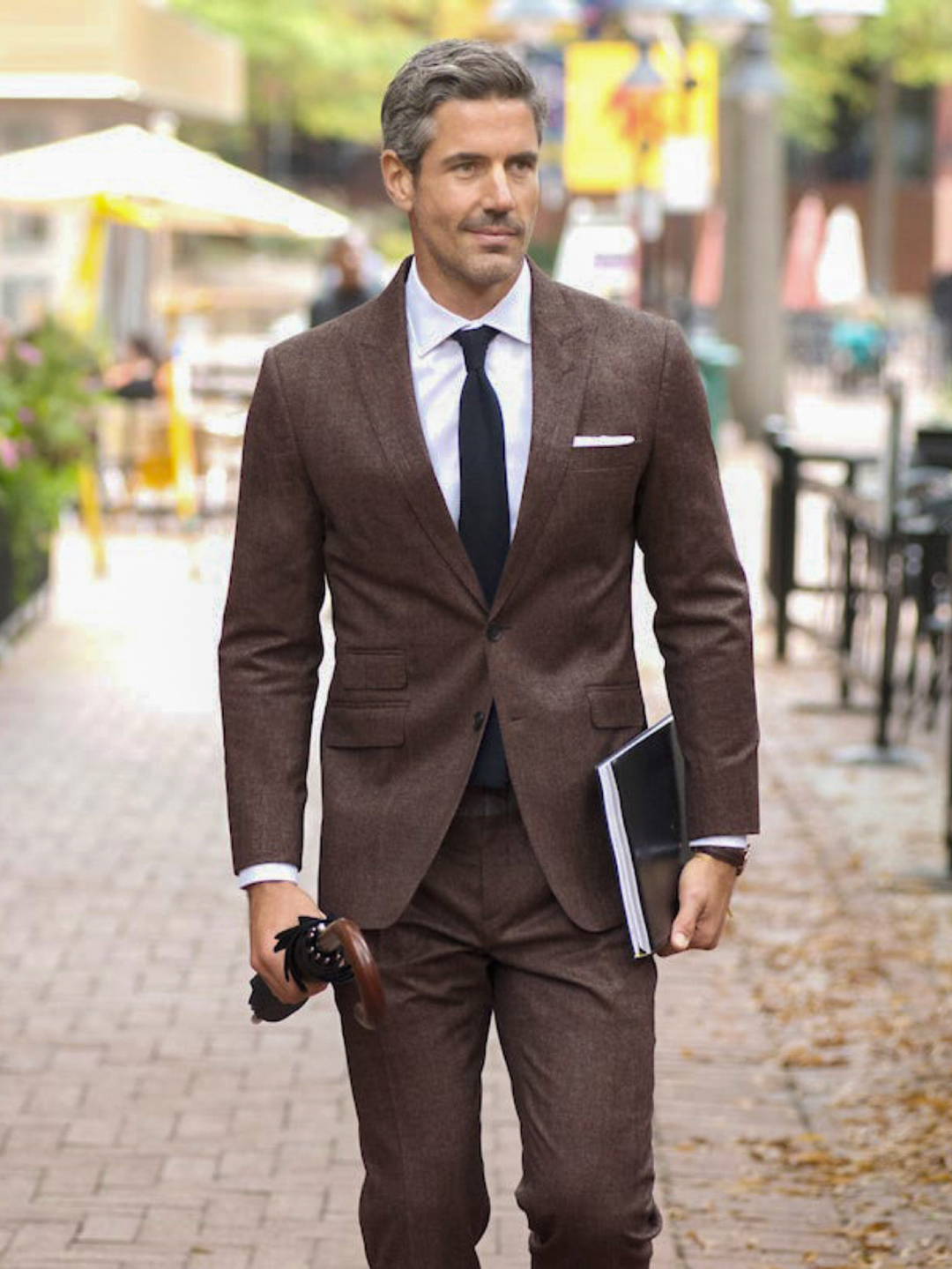 brown suit white dress shirt and solid black tie