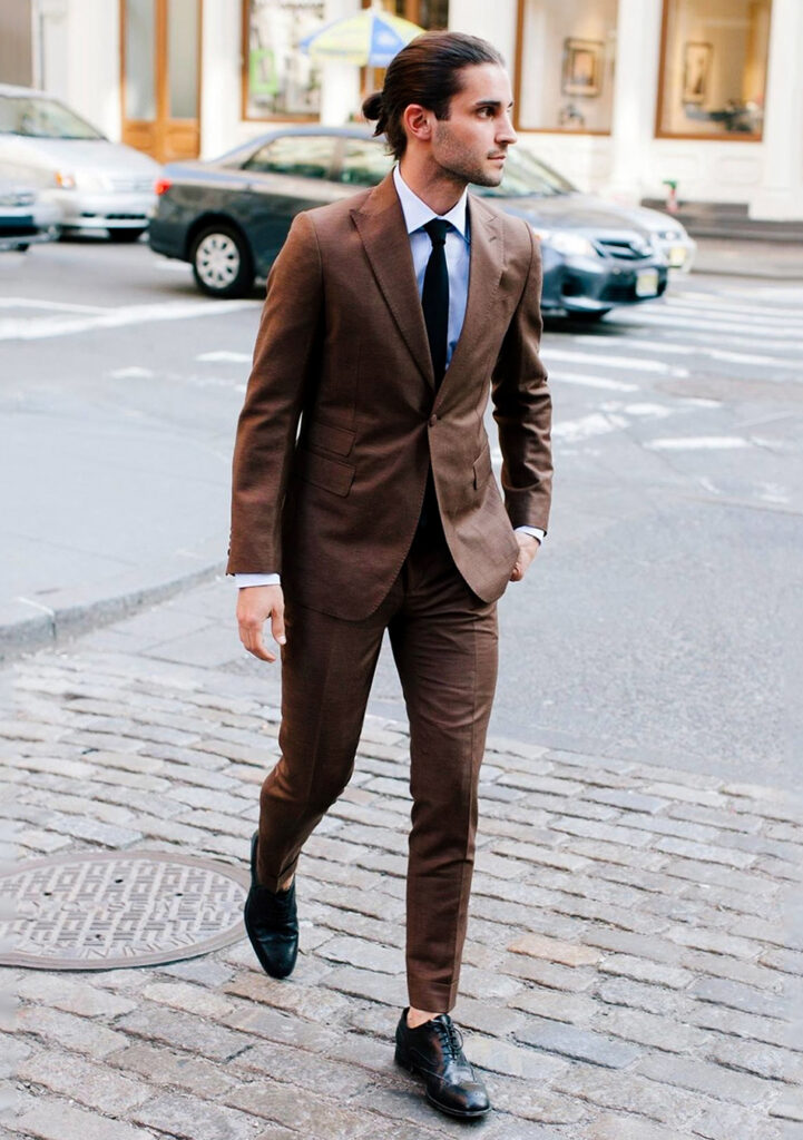 Brown suit, white dress shirt, black tie, and black brogues