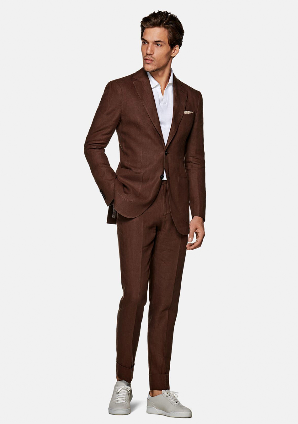 Brown suit, white polo t-shirt, and light grey sneakers