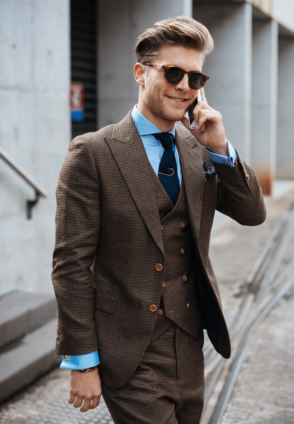 Brown three-piece suit with blue shirt and navy tie