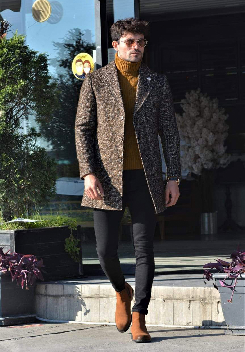 Brown tweed coat, orange turtleneck, black jeans, and brown Chelsea boots