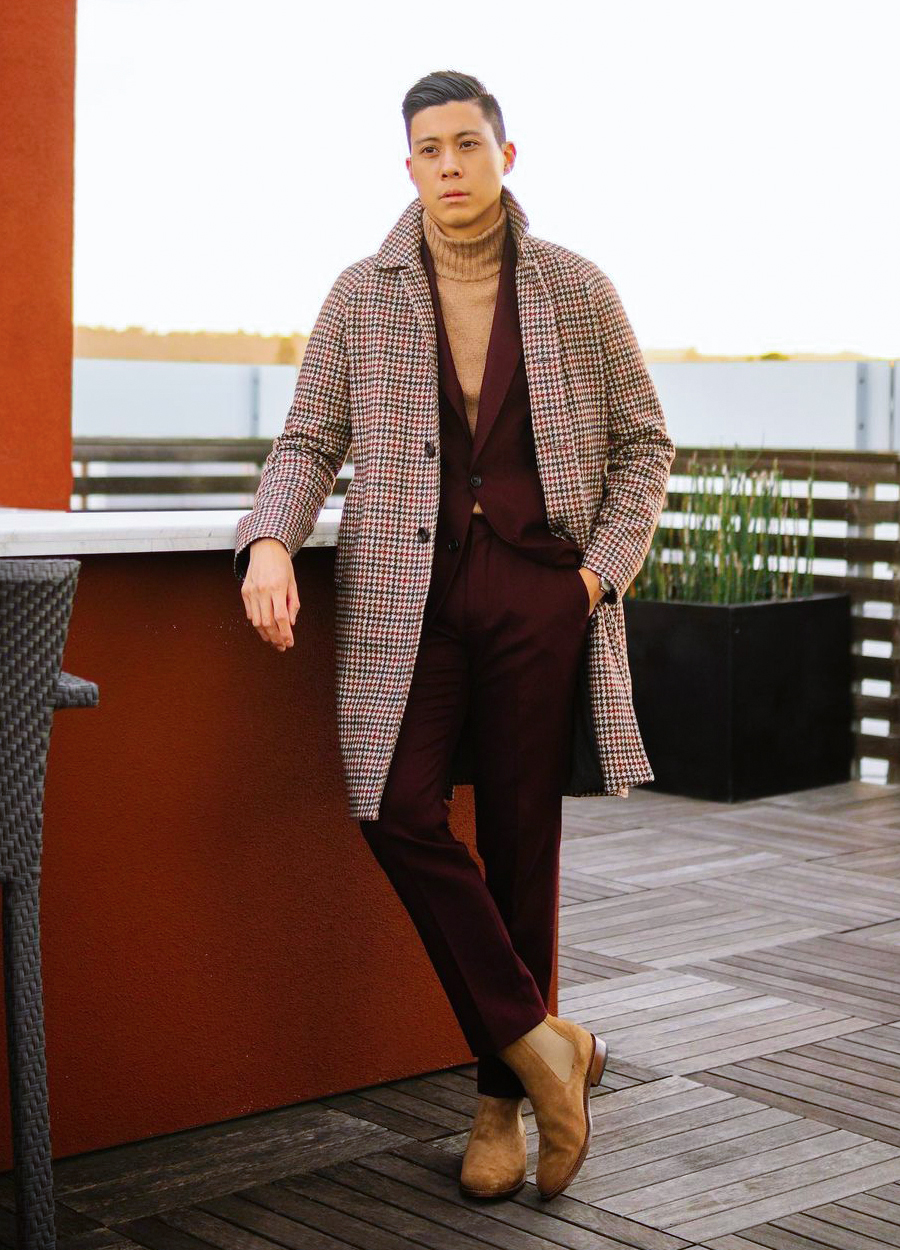 Wearing a burgundy suit with a tan turtleneck and brown houndstooth ovecoat