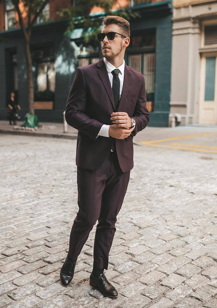 Burgundy suit, white dress shirt, black tie, and black derby shoes