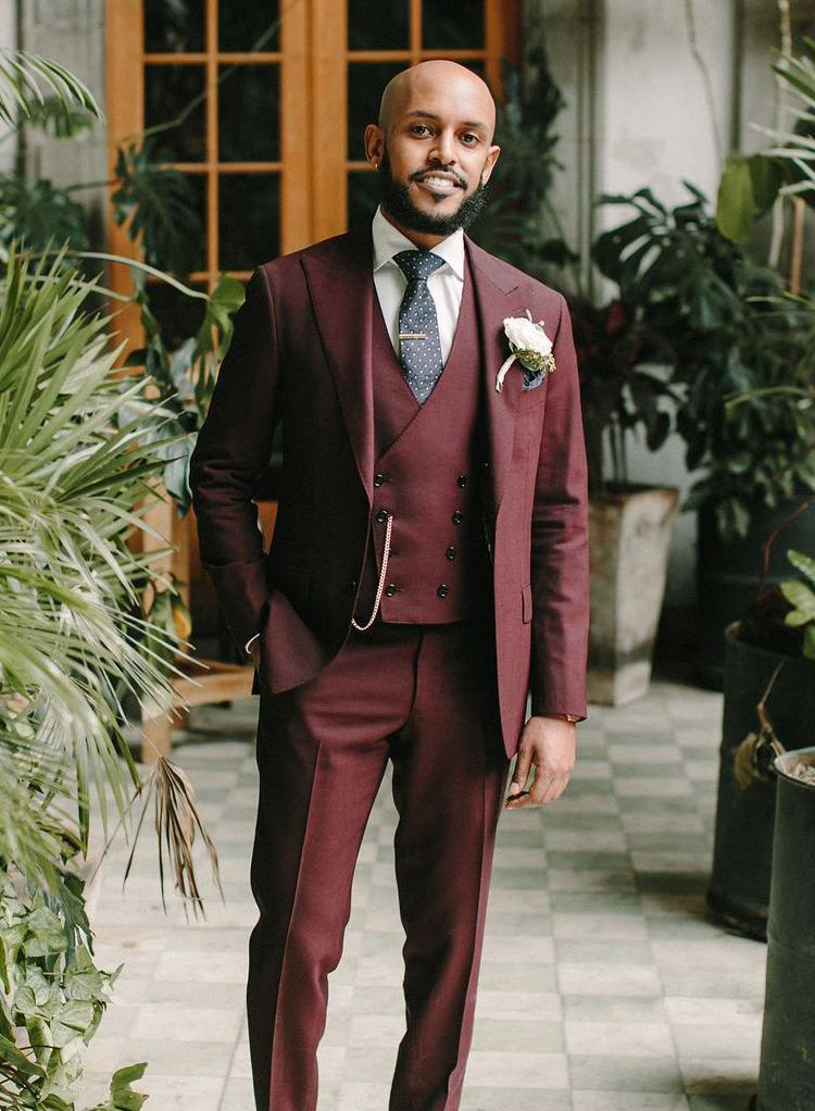 Burgundy three-piece suit with white shirt and navy dotted tie