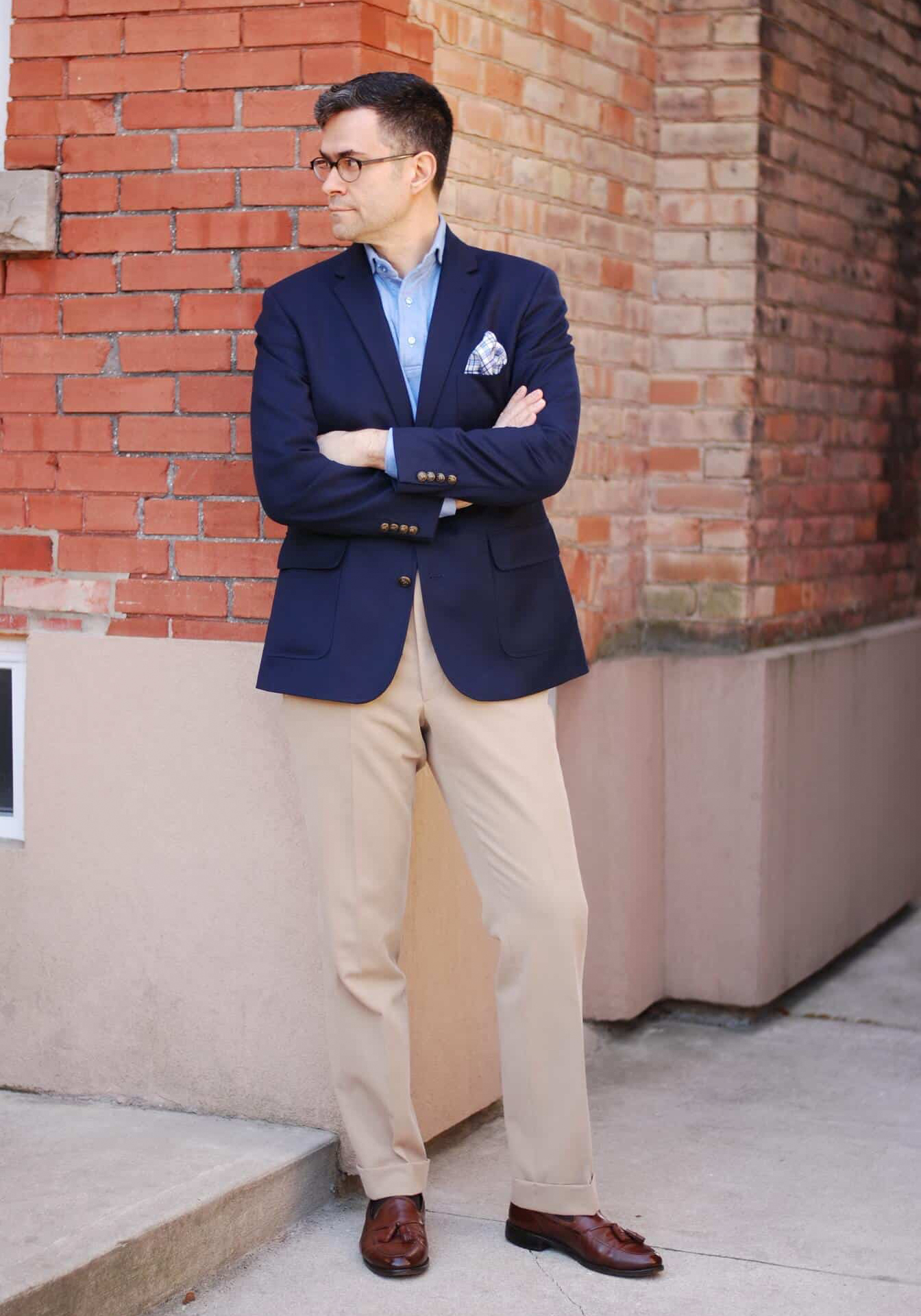 Navy suit jacket, blue shirt, tan pants, and brown shoes