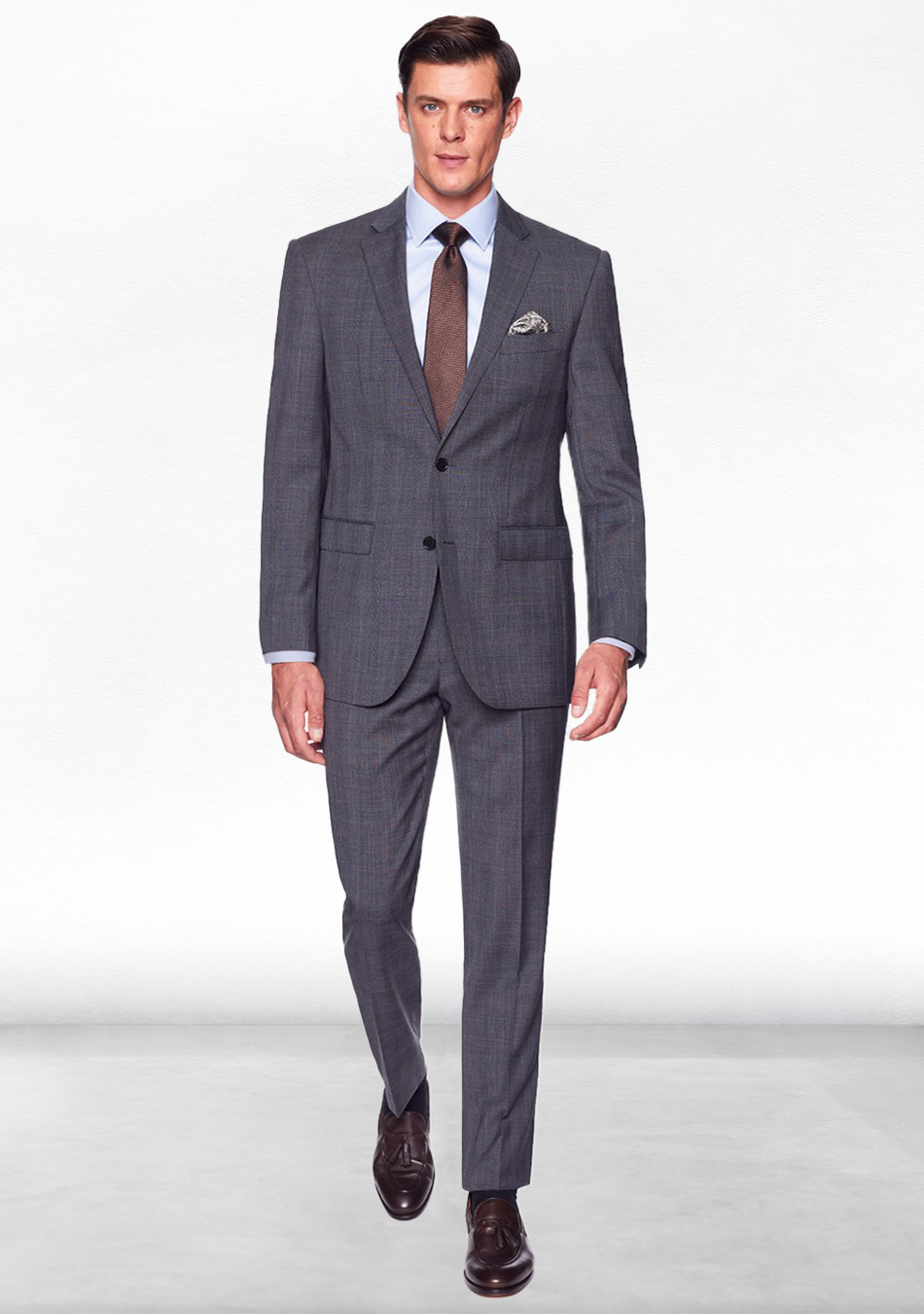 Charcoal grey suit, blue dress shirt, brown tie, and brown loafers