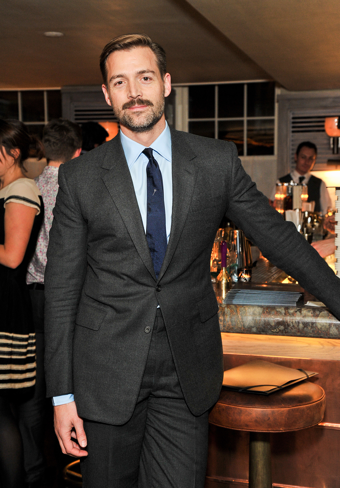 Charcoal grey suit with light blue shirt and navy tie