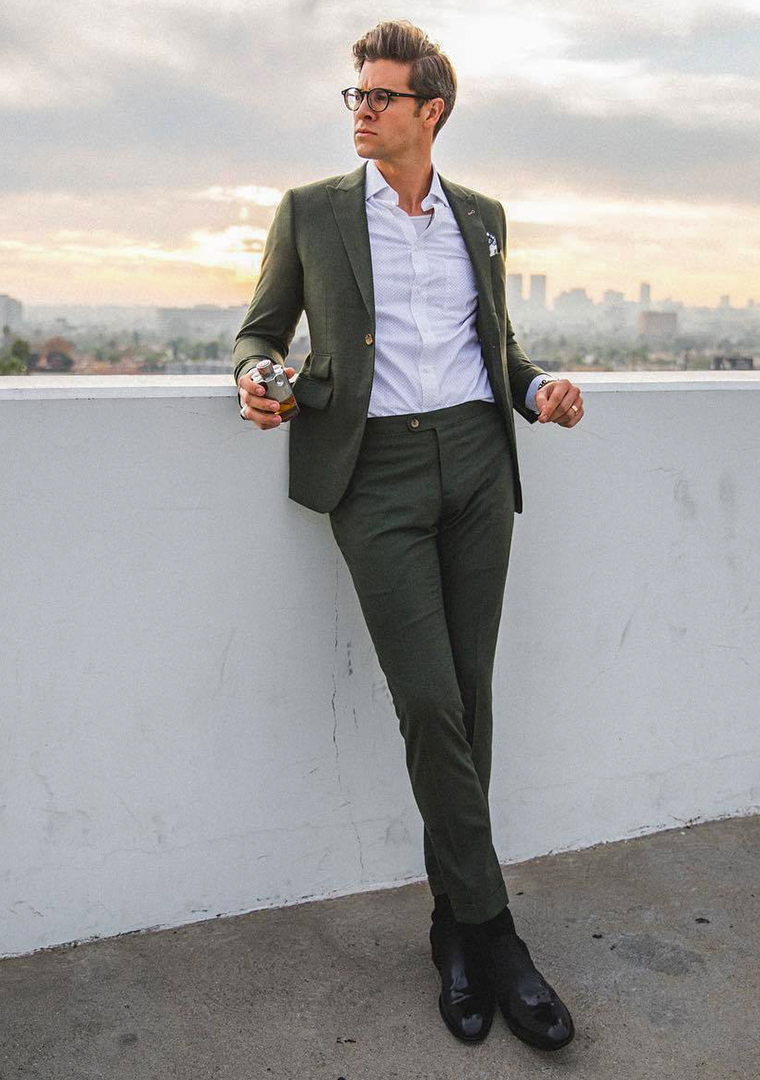 Dark green suit, white dress shirt, and black leather Chelsea boots