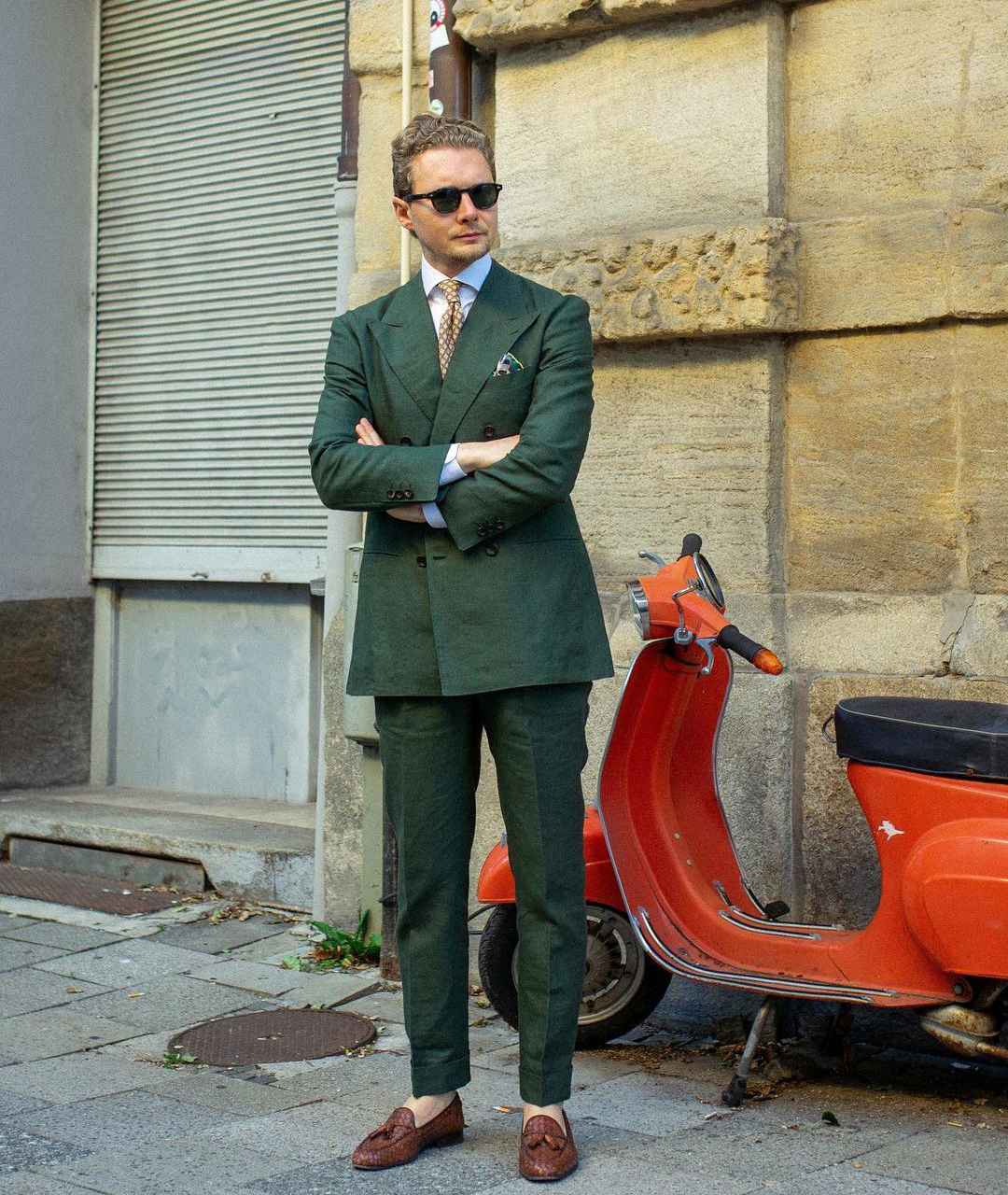 Double-breasted green suit with a white shirt and brown tie and loafers