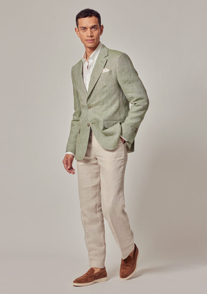 Green blazer, white dress shirt, beige pants, and brown loafers