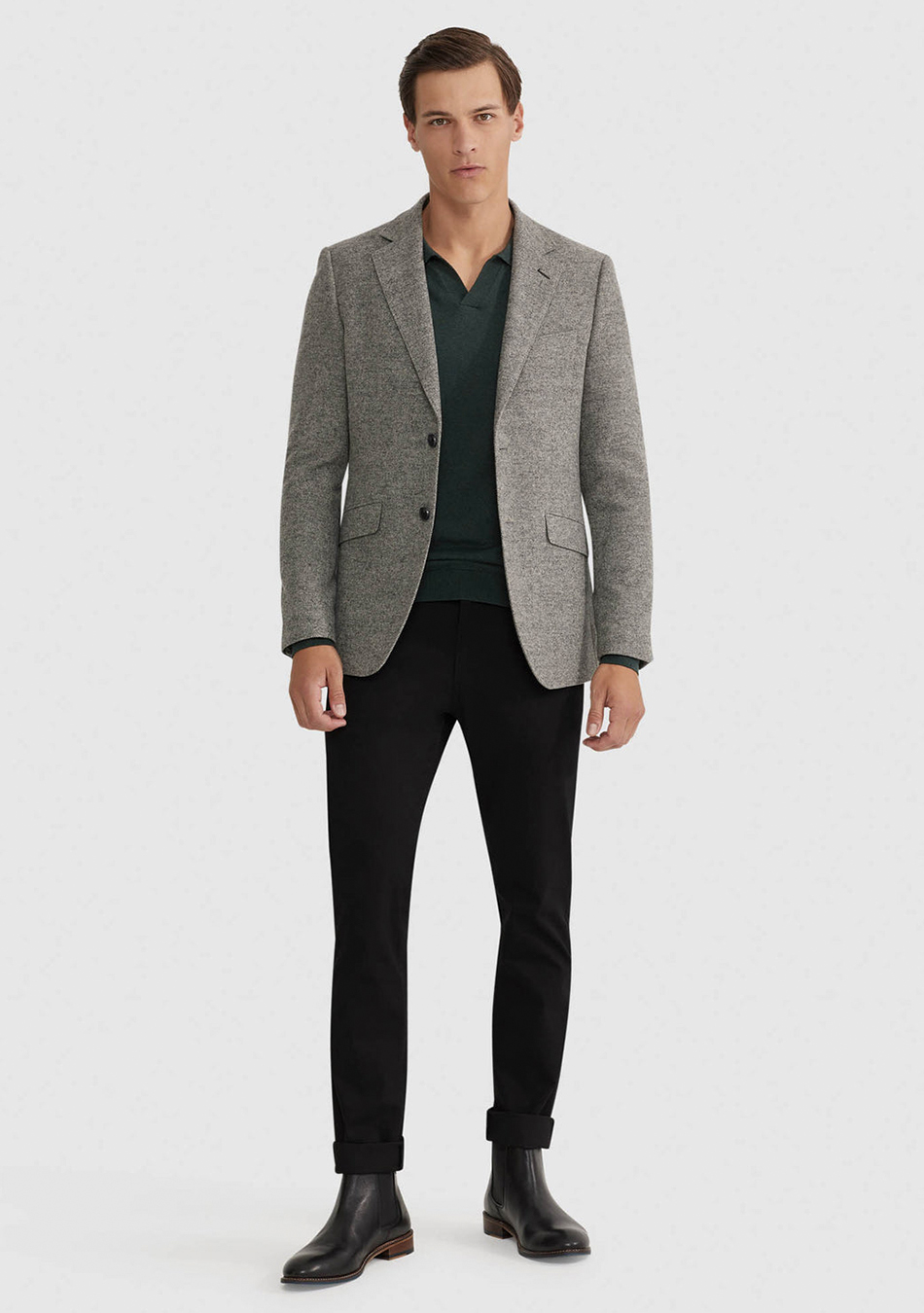Grey blazer, green polo T-shirt, black jeans, and black Chelsea boots