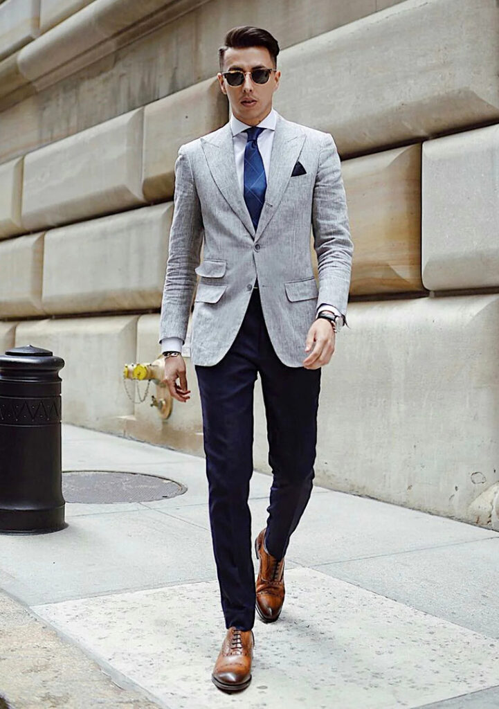 Grey blazer, navy pants, and brown Oxford shoes
