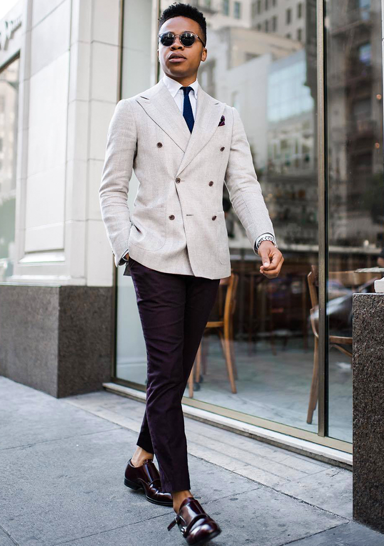 Grey double-breasted blazer, white dress shirt, blue tie, black chinos, and burgundy monk strap shoes