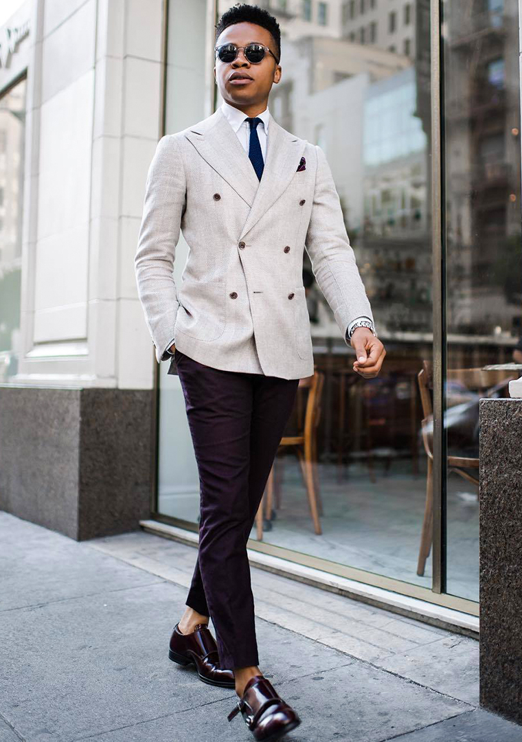 grey double breasted blazer white dress shirt blue tie black chinos and burgundy monk strap shoes