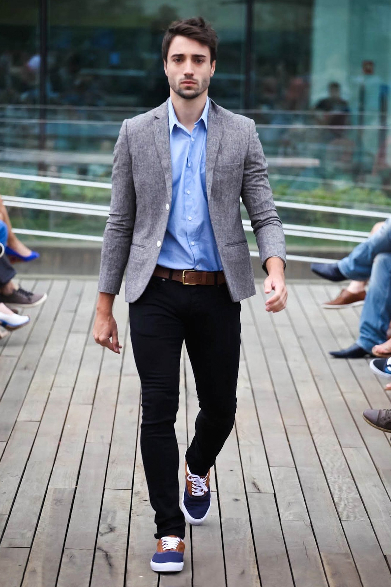 Grey jacket, blue shirt, black pants, and blue minimal sneakers