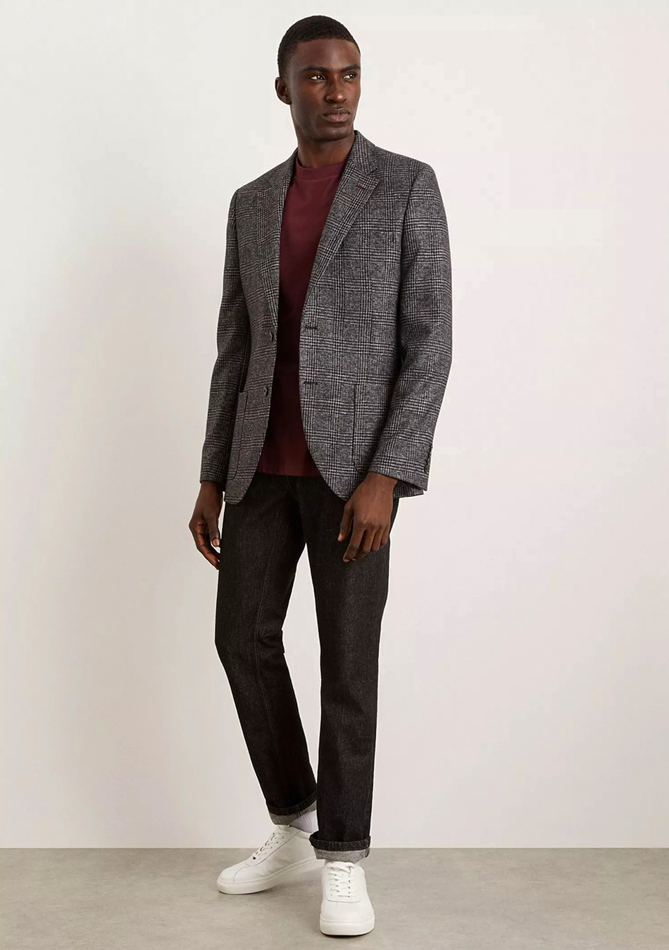 Grey plaid blazer, burgundy crew-neck sweater, black jeans, and white sneakers