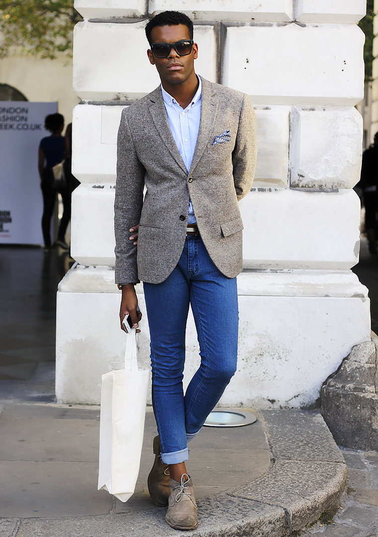 Grey plaid blazer, white shirt, blue jeans, and tan chukka boots