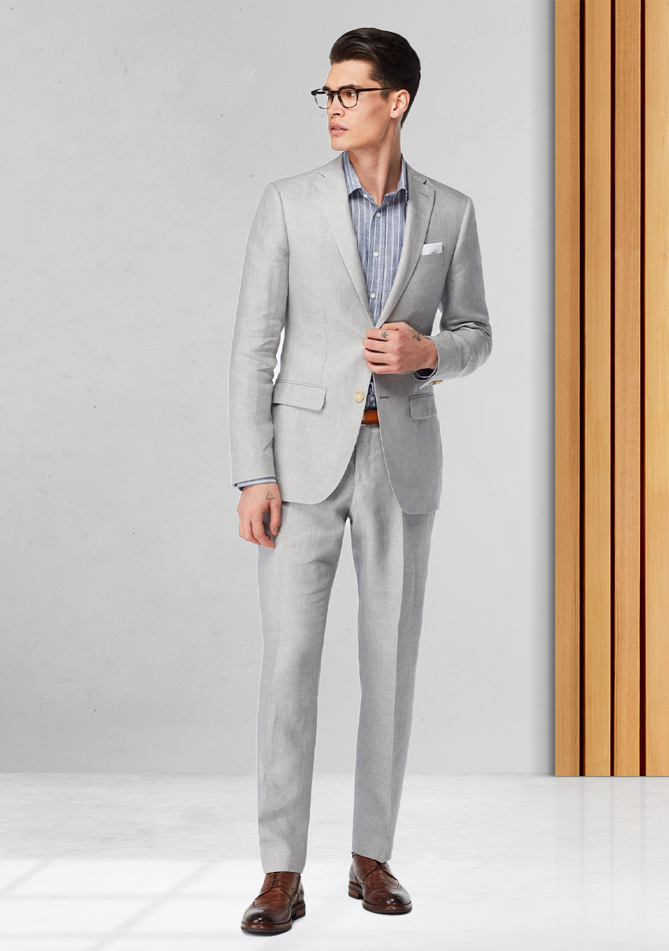 Grey suit, blue patterned shirt, and brown derby brogue shoes