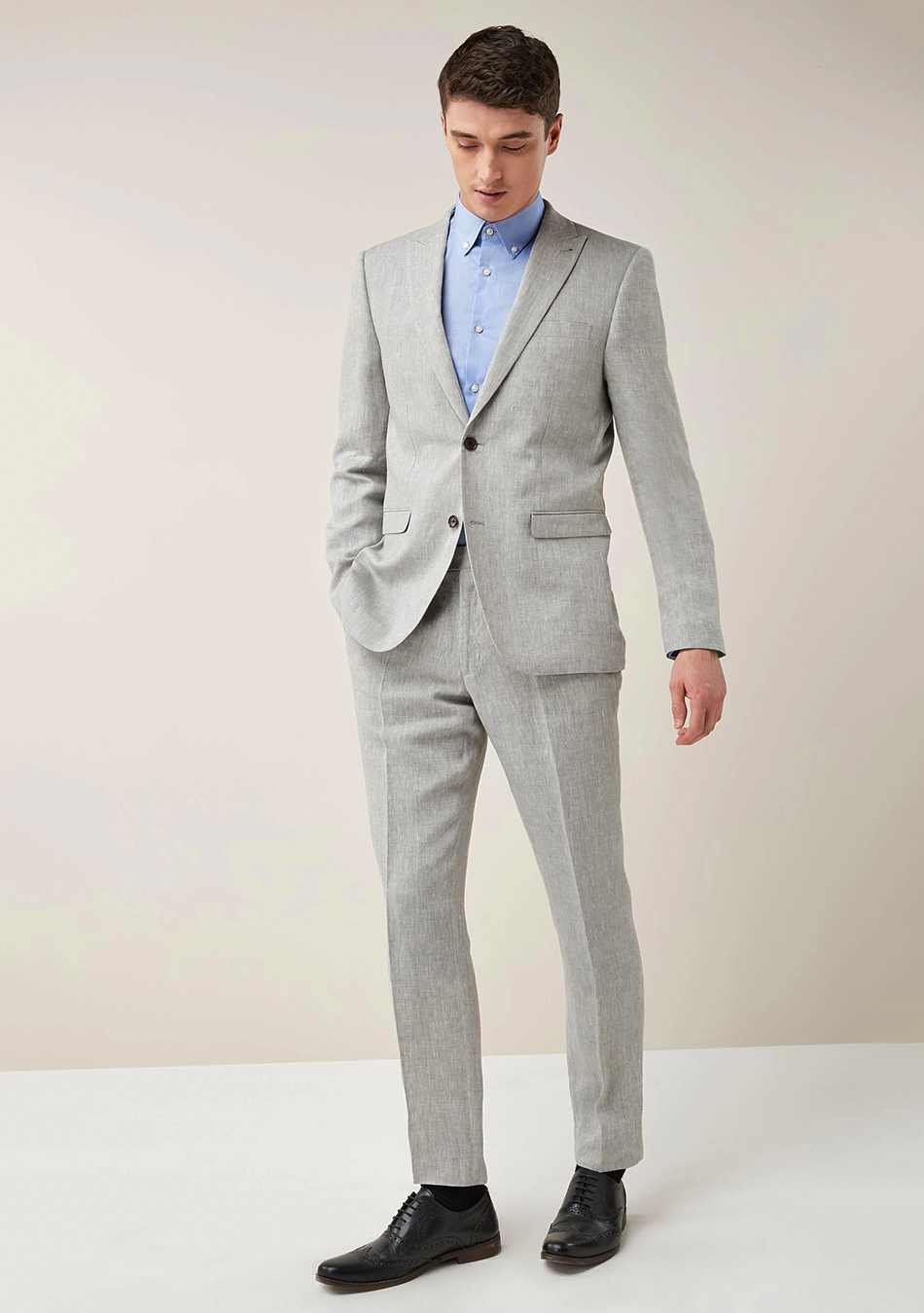 Grey suit, blue shirt, and black Oxford shoes
