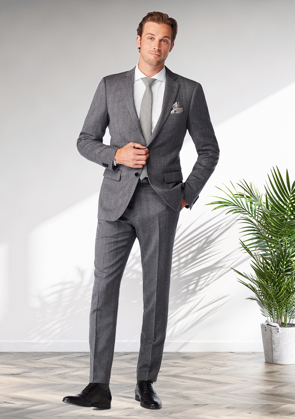 Grey suit, white dress shirt, grey tie, and black Oxford shoes