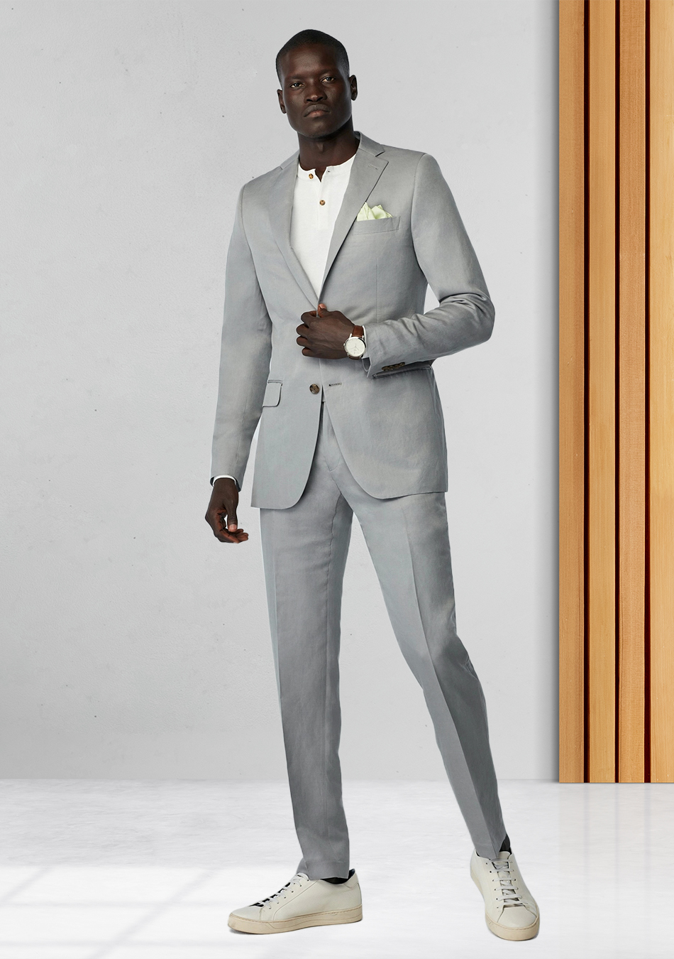 Grey suit, white Henley shirt, and off-white sneakers