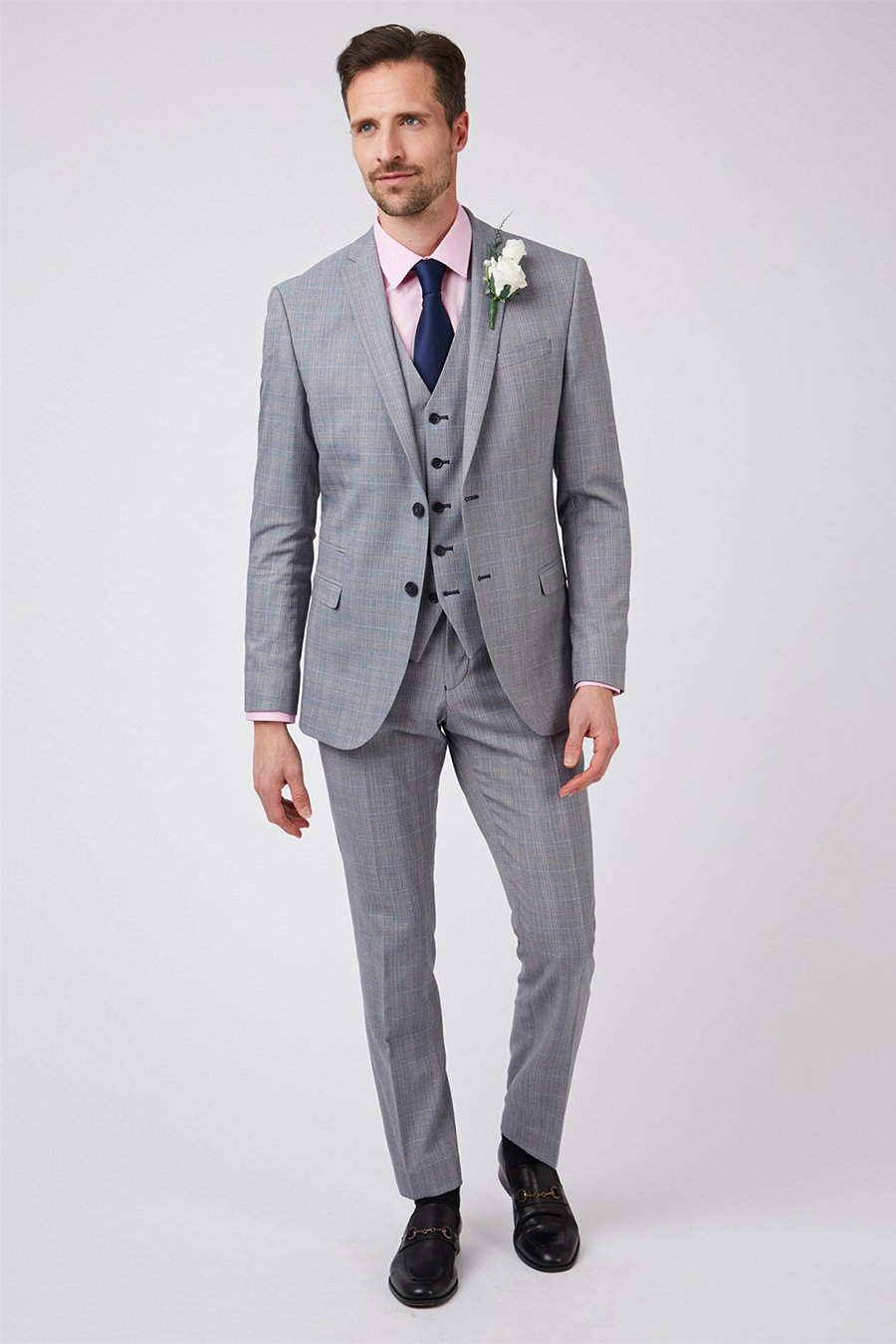 Grey three-piece suit, pink shirt, navy tie, and black loafers