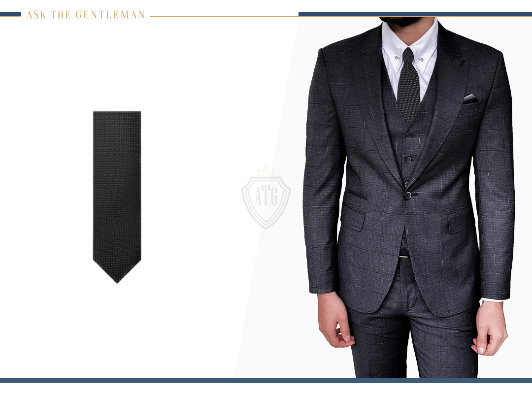 How to wear a charcoal three-piece suit with subtle patterns with a white shirt and dark grey tie