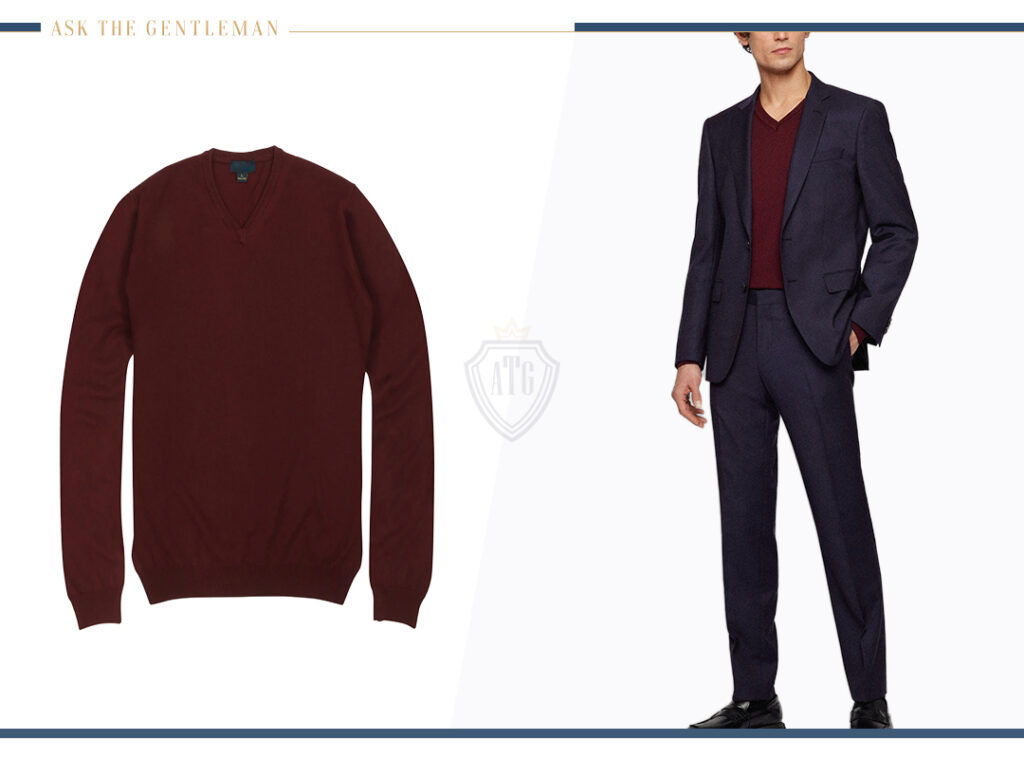 Wearing a navy wool suit with a burgundy v-neck woolen sweater