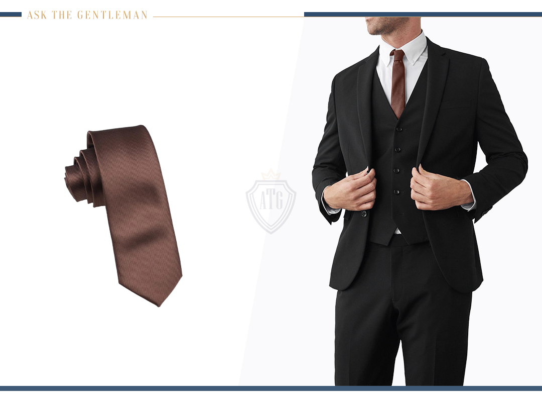 How to wear a three-piece black suit with a brown tie