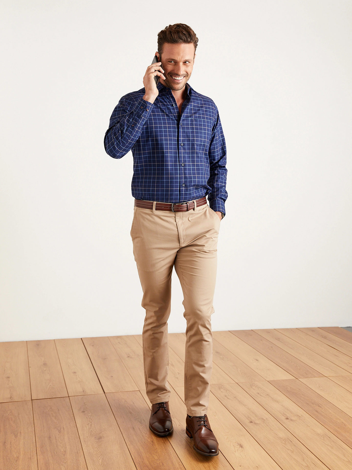 Casual Friday outfit: khaki pants, navy blue shirt, brown shoes, and brown belt