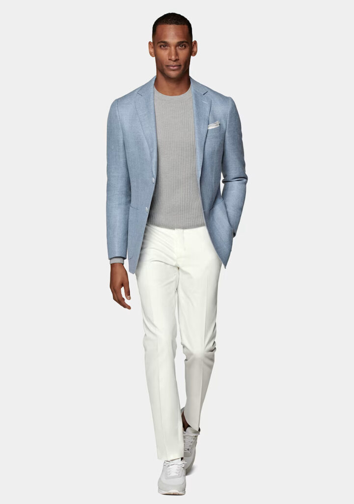 Light blue blazer, grey sweater, and white pants