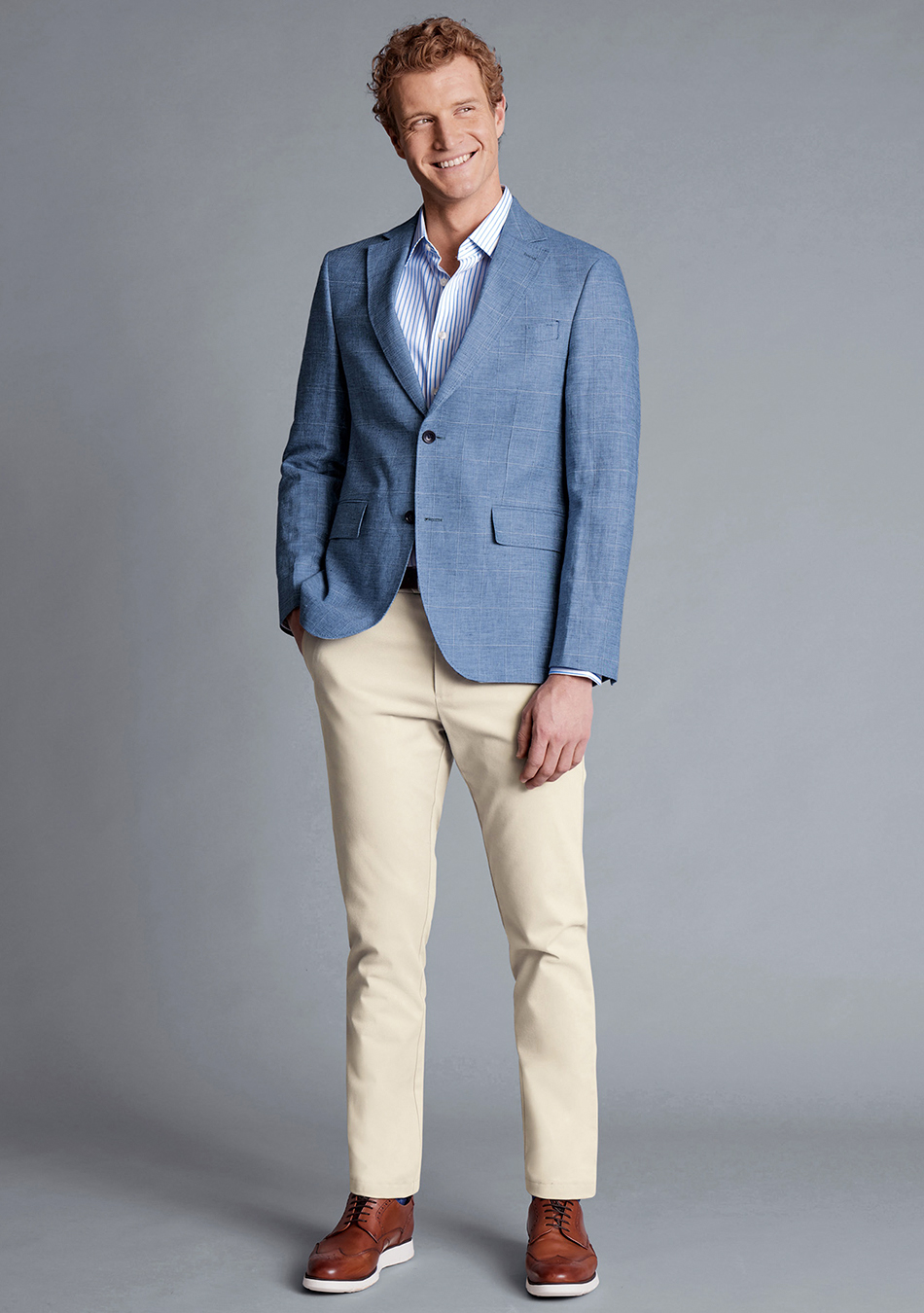 Light blue blazer, striped tie, and tan pants