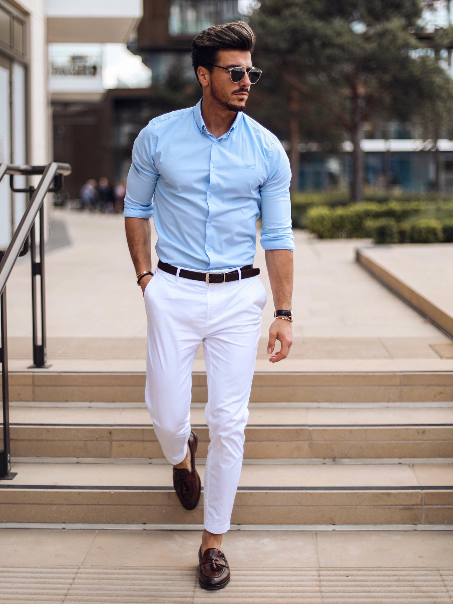 Light blue dress shirt, white pants, brown loafers, and brown belt