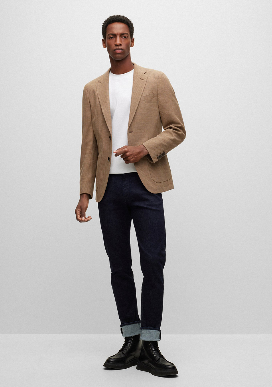 Light brown blazer, white T-shirt, navy jeans, and black dress boots