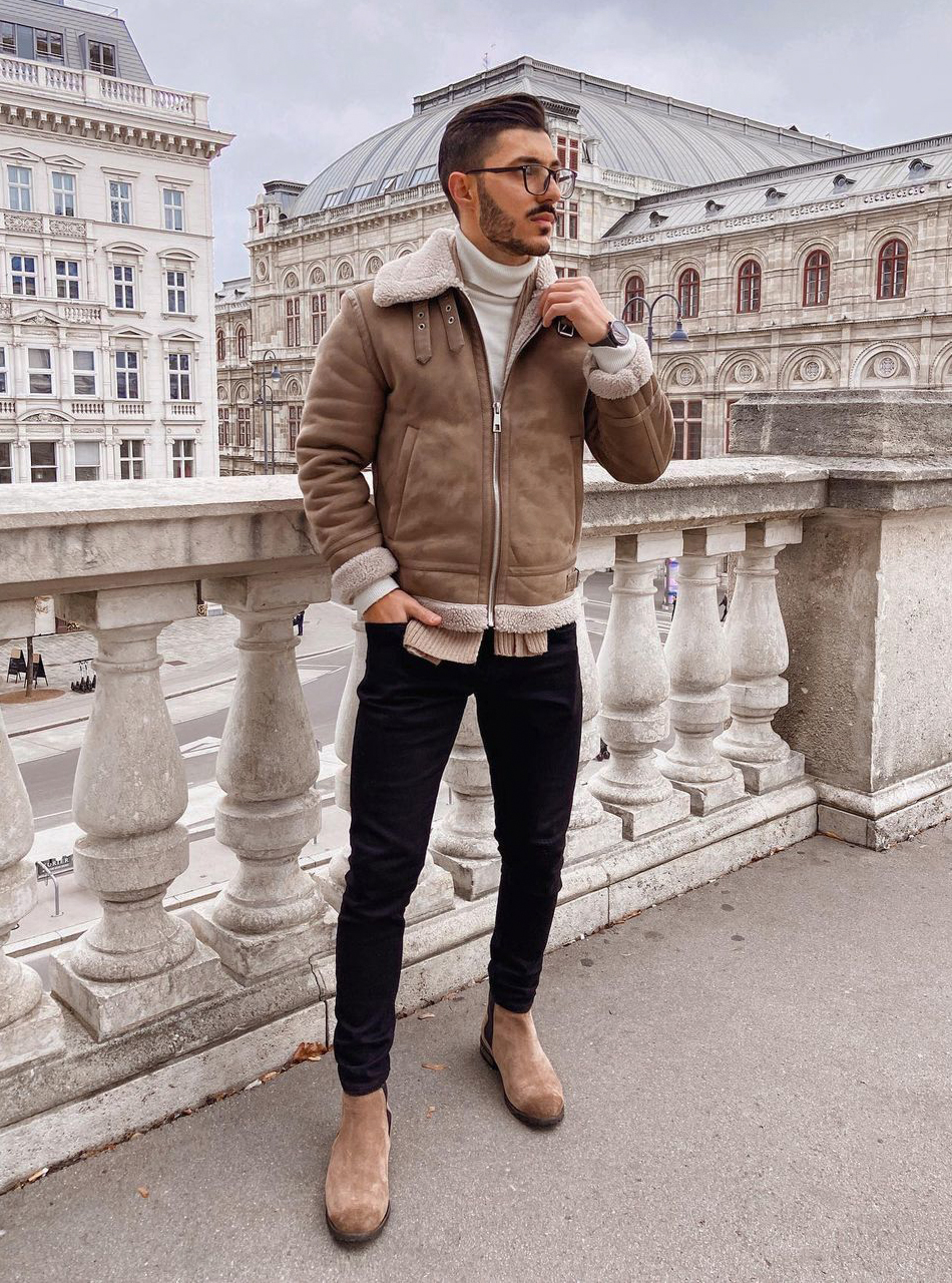 Light brown jacket with beige turtleneck. black jeans, and tan Chelsea boots